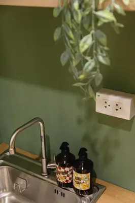 a kitchen sink with two bottles of soap on it at Patong Apartments Steps to Beach & Bangla Road Sleeps 6 in Patong Beach