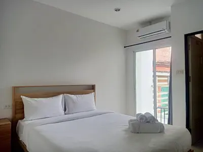 a white bed with a pair of towels on it at 07 Antalya Boutique Hotel in Patong Beach
