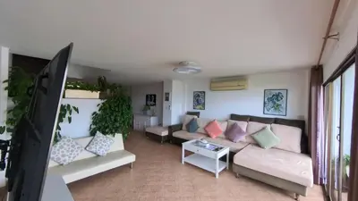 a living room with a couch and a table at Eagles Nest Patong in Patong Beach