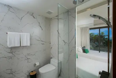 a white bathroom with a shower and a toilet at The Heights Penthouse A5 3Bedrooms Seaview near Kata Beach in Kata Beach