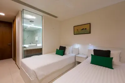 a hotel room with two beds and a bathroom at The Heights Penthouse A5 3Bedrooms Seaview near Kata Beach in Kata Beach