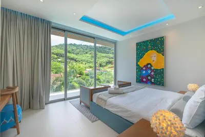 a bedroom with a bed and a large window at Luxury Pool Villa in Nai Harn - Villa Solana in Rawai Beach