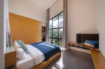 a bedroom with a large bed and a large window at BangT-ao 3-bedroom modern minimalist luxury style private pool holiday villa gym quiet community in Bang Tao Beach