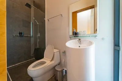 a bathroom with a toilet and a sink and a shower at BangT-ao 3-bedroom modern minimalist luxury style private pool holiday villa gym quiet community in Bang Tao Beach