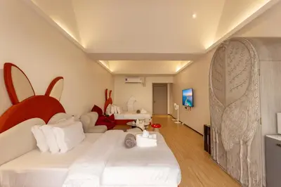 a bedroom with a bed with a bunny head on it at YUSU Hotel \u7fbd\u5bbf\u9152\u5e97 in Phuket Town
