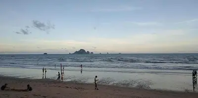 a group of people playing on the beach at By the Sea Apartment Hotel in Krabi town