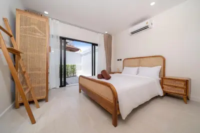 a bedroom with a bed and a large window at Brand New 4BR Balinese Style Pool Villa Kaia just 5 min drive from NaiHarn Beach in Rawai Beach