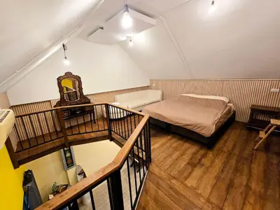 a small room with a bed and a staircase at Baibon2 Homestay Thalang Phuket in Thalang