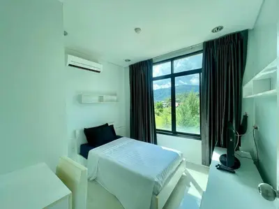 a white bedroom with a bed and a window at Kamala Regent Condo in Kamala Beach