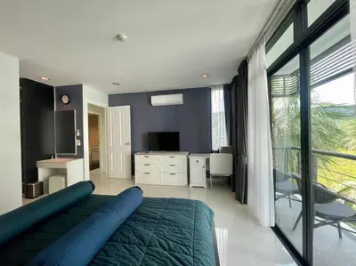 a bedroom with a large bed and a large window at Kamala Regent Condo in Kamala Beach