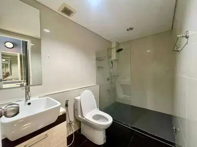 a bathroom with a white toilet and a sink at Kamala Regent Condo in Kamala Beach