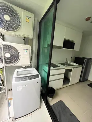 a small kitchen with a stove and a sink at Centrio room in Ban Rangeng