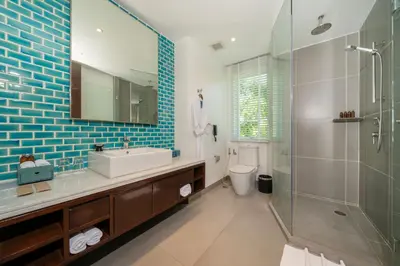 a bathroom with a sink and a glass shower at Karon Beachfront Apartment 724 in Karon Beach