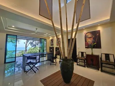 a living room with a table and a vase at Beachfront villa in Rawai in Phuket Town