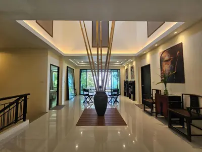 a hallway with a large vase in the middle of it at Beachfront villa in Rawai in Phuket Town