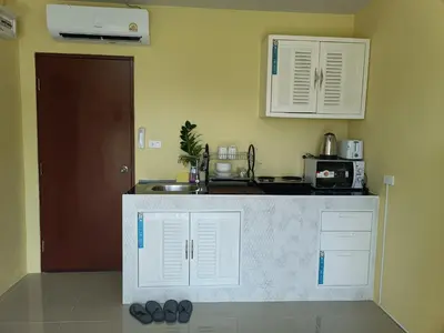 a kitchen with a sink and a counter top at Yellow house in Ban Saiyuan (1)