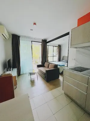 a living room with a couch and a bed at 04near Shopping Malls and Naka night market in Phuket Town