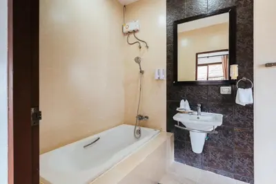 a bathroom with a bath tub and a sink at San pool villa in Patong Beach
