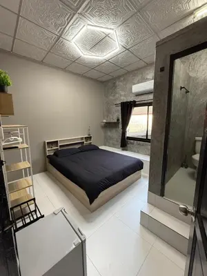 a bedroom with a bed and a mirror and a sink at Green Dreams Guesthouse in Ban Lo Long