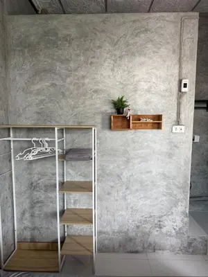 a staircase in a room with a concrete wall at Green Dreams Guesthouse in Ban Lo Long