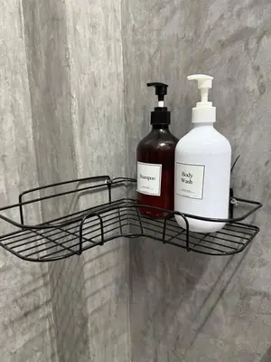 a black shelf with two bottles of soap on it at Green Dreams Guesthouse in Ban Lo Long