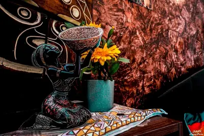 a table with two vases and a vase with flowers at DANK Hotel 420 friendly Patong Phuket in Patong Beach