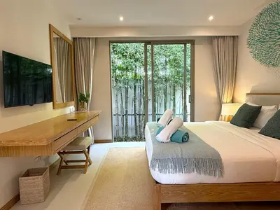 a bedroom with a bed and a desk and a desk at Luxury 3BR Pool Villa near Blue Tree - Bang Tao in Amphoe Kathu