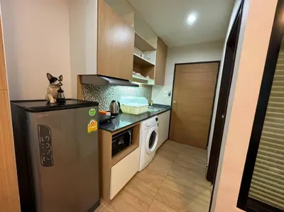 a kitchen with a cat sitting on top of a refrigerator at คอนโดใกล้หาดในทอนNai Thon Beach Room A410 in Nai Thon Beach