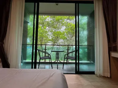 a bedroom with a table and chairs on a balcony at คอนโดใกล้หาดในทอนNai Thon Beach Room A410 in Nai Thon Beach