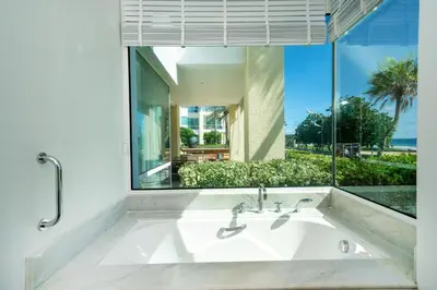 a bathroom with a sink and a large window at Karon Beachfront Apartment 703 in Karon Beach