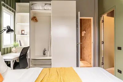 a bedroom with a bed and a desk and a table at The Rich Villas House Pool Chalong Robinson in Ban Suan