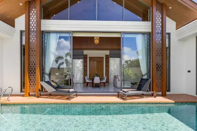 a house with a swimming pool and a patio at The Ozon Bangtao 3-bedrooms Villas with pool by My Home Phuket in Laguna Phuket