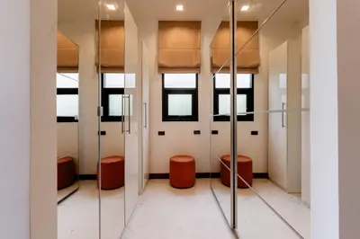 a walk in shower room with orange stools at Villa Viola 7 Bedroom, Fully Staffed, on the Golf Course in Laguna Phuket