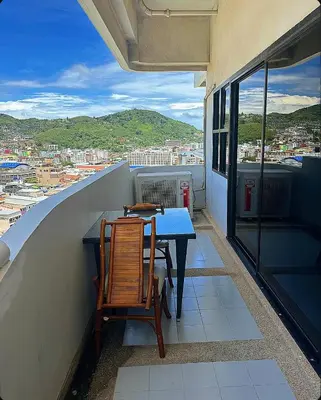a table and chairs on a balcony with a view at Patong Tower Near Beach in Patong Beach