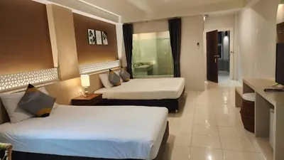 a hotel room with two beds and a television at iRest Ao Nang Hostel in Ao Nang Beach