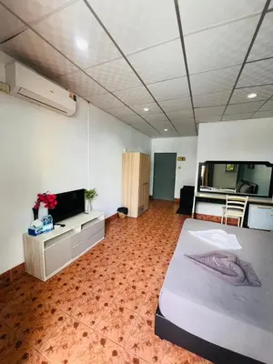 a large room with a bed and a flat screen tv at Patong Adventure Hostel in Patong Beach