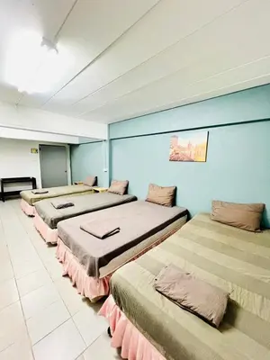 a row of beds in a room with blue walls at Patong Adventure Hostel in Patong Beach