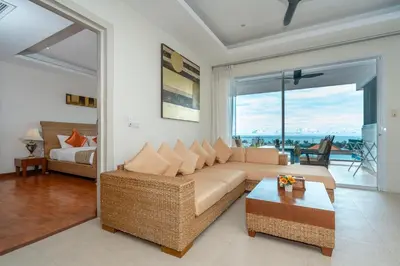a living room with a couch and a bed at Hillside Seaview Residence in Karon Beach