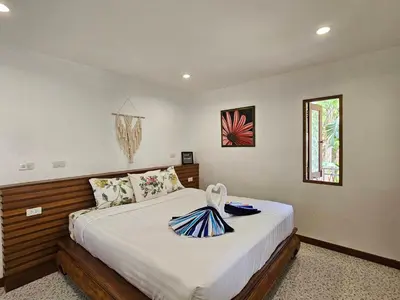a bedroom with a large bed in a room at Tropical Oasis Aoyon Beach House in Ban Ao Makham
