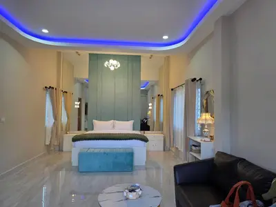 a large bedroom with a bed and a couch at Tropical Oasis Aoyon Beach House in Ban Ao Makham