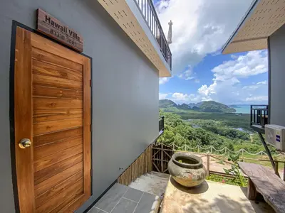 a room with a door and a balcony with a view at Samet Nangshe Goodview in Ban Met Nang Chi