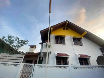a white building with a yellow roof at Kata#near macro karon # 1km to kata beach in Karon Beach