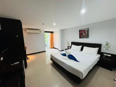 a bedroom with a bed with a blue bird on it at La Casa Patong in Patong Beach