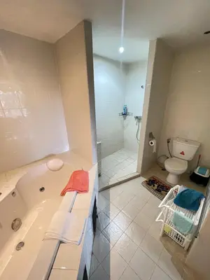a bathroom with a bath tub and a toilet at Rawai apartments in Ban Saiyuan (1)