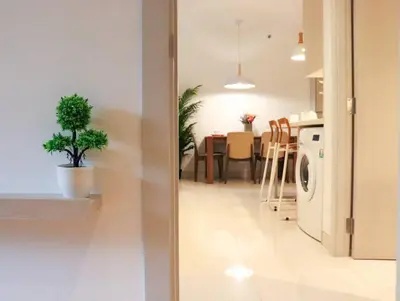 a kitchen and a living room with a washing machine at Cassia Residences Sea View in Laguna Phuket