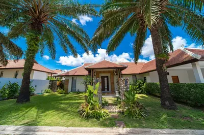 a house with palm trees in front of it at Luxury 4 Bedrooms 800 square meters of large space Private swimming pool private kitchen service Family and friends vacation in Bang Tao Beach