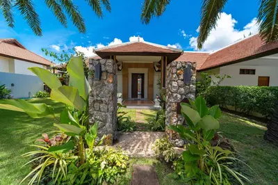 a house with a pathway leading to the front door at Luxury 4 Bedrooms 800 square meters of large space Private swimming pool private kitchen service Family and friends vacation in Bang Tao Beach