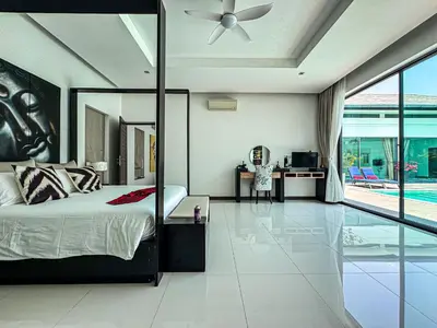 a bedroom with a bed and a ceiling fan at VILLA DESTINY - Luxury Villa Near Nai Harn Beach in Ban Saiyuan (1)