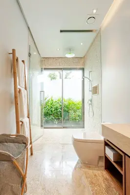 a bathroom with a tub and a shower with a window at Stylish Pool Villa Tropical Hideaway in Ban Phru Champa