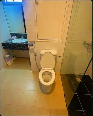 a bathroom with a toilet and a sink at Patong Tower Mountain View in Patong Beach